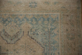 Mostly even wear and low pile on the geometric corner of a vintage Afshar rug.