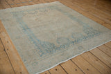 Angled perspective of a vintage distressed Afshar rug highlighting its low pile and soft, worn texture.