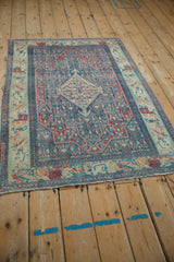 Vintage distressed Senneh rug with a traditional Persian pattern, viewed from a high angle.