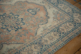 Softened sapphire blue and pale terracotta floral motifs on a distressed vintage Tabriz rug.