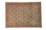 Distressed vintage Senneh rug with a geometric Herati pattern in decorative rust, silver, and dusty teal.