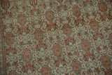 Detailed view of the distressed pile revealing rust turtle samovar motifs on a silver and teal field.