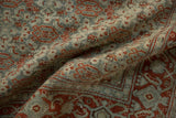 Low pile texture of a vintage Senneh rug with rust and dusty teal Herati pattern details.