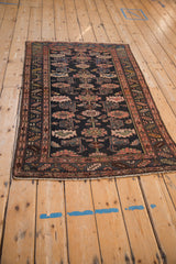 Kurdish Hamadan rug corner with short fringe, blush serrated leaf border, and floral guls.