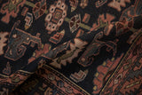 Close-up of vintage Kurdish Hamadan rug's hand-knotted pile with navy and rose floral guls.