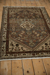 Distressed vintage Hamadan rug, showing faded Herati motifs in silver, ivory, and burgundy.