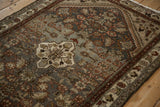 Distressed vintage Hamadan rug section, featuring Herati pattern with time-softened silver, wine, and rose.