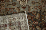 Vintage distressed Hamadan rug corner, revealing hand-knotted foundation, fringe, and muted Herati pattern.