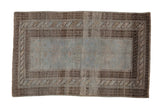 Vintage distressed Belouch rug with a heavily abrashed pale blue field and dark chocolate brown geometric borders.