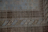 Multi-tiered borders in denim blue and chocolate brown showing even wear to the knot heads.