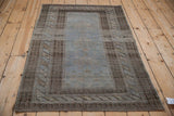 Angled view of the distressed Persian Belouch rug showing its decorative wear.