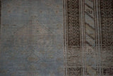 Detail of the distressed rug's texture, showing mostly even wear down to the knot heads.