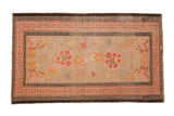 Antique Ningxia rug: beige field, double floral medallion, blooming branches, charcoal running-T border.