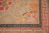 Antique Ningxia rug detail showing pink blooming branches and the running-T border.