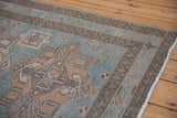 Meandering vine and blossom main border on a distressed vintage Persian Hamadan rug.