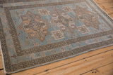 Intact side cord selvage and geometric border on a vintage distressed Persian Hamadan rug.