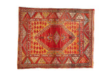 Vintage Anatolian rug with cherry red diamond medallion, saffron yellow abrashed field, floral borders.