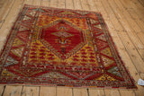 Vintage Anatolian rug corner close-up, showing intact fringe and geometric halved floral gul border.
