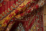 Textured cherry red, saffron yellow Anatolian rug, geometric guls visible, fringed edge.