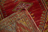 Hand-knotted Anatolian rug corner, contrasting red pile and reverse side's geometric border design.