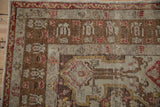 Corner detail of a vintage Anatolian rug with pawn and germinating blossom motifs in the border.