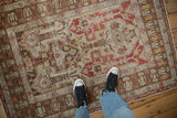 A soft, worn pile and warm geometric pattern of a distressed vintage Anatolian rug from above.