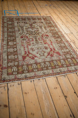Angled perspective of the distressed vintage Anatolian rug, showing the full pattern and time-softened patina.