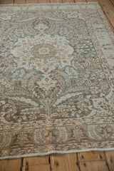 Low angle perspective of the vintage Tabriz rug's even wear and intricate floral design.