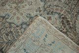 Corner view showing the distressed pile and hand-knotted back of a vintage Tabriz.
