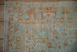 Close-up of the machine-bound edge and worn, low pile of a distressed vintage Afshar rug.