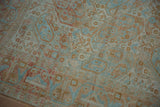 Close-up of the distressed pile showing floral botehs in powder blue and pale terra cotta.