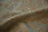 Distressed low pile of a vintage Afshar rug showing soft terra cotta and blue boteh motifs.