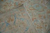 Folded corner of a vintage Afshar rug showing the hand-knotted foundation and machine-bound edge.