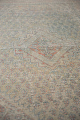 Angled view of the vintage Arak rug's worn pile, showing textured knots and visible foundation.