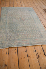 Angled view of the vintage Arak rug highlighting its time-softened design and evenly distressed texture.