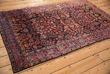 Perspective view of a Mohajeran Sarouk rug showing its intricate floral field and palmette borders.