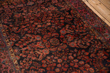 Intricate floral sprays and bouquets on the dark navy field of an antique Sarouk rug.