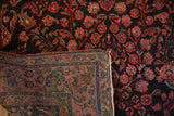 The detailed hand-knotted back and plush floral pile of an antique Mohajeran Sarouk rug.