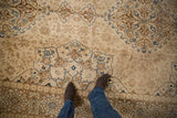 Mostly even short pile on a vintage Tabriz carpet showing its floral field and cartouche border.