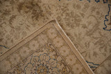 Hand-knotted foundation and secured selvage of a distressed vintage Persian Tabriz carpet.