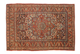 Antique Kashan rug displaying central medallion, cherry red, navy blue florals, and scattered birds.