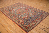 Antique Kashan rug border showcasing cherry red floral vines and side cord selvage.