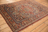 Antique Kashan rug corner, displaying intricate floral arabesques in sapphire blue and cherry red.