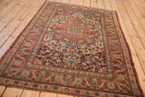 Fine antique Persian Kashan rug: cherry red and sapphire floral arabesques on side border.