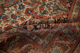 Early 20th century antique Kashan rug's intricate floral vines and arabesques in ruby red and sapphire blue.