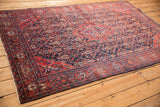 Antique Sarouk rug corner with its madder red spandrel and intricate Turtle Samovar border motif.