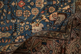 Rolled corner of a hand-knotted Arak rug contrasting the sapphire blue field and dusty rose border.