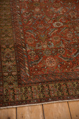 Angled view of the antique Malayer's henna plant main border and serpent inner border.