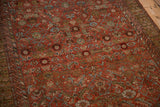 Evenly worn pile of an antique Malayer rug revealing geometric fish and bird motifs in rust and blue.