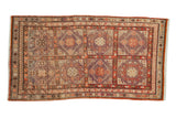 Vintage distressed Khotan rug with repeating geometric panels in pale aubergine, violet, and faded red.